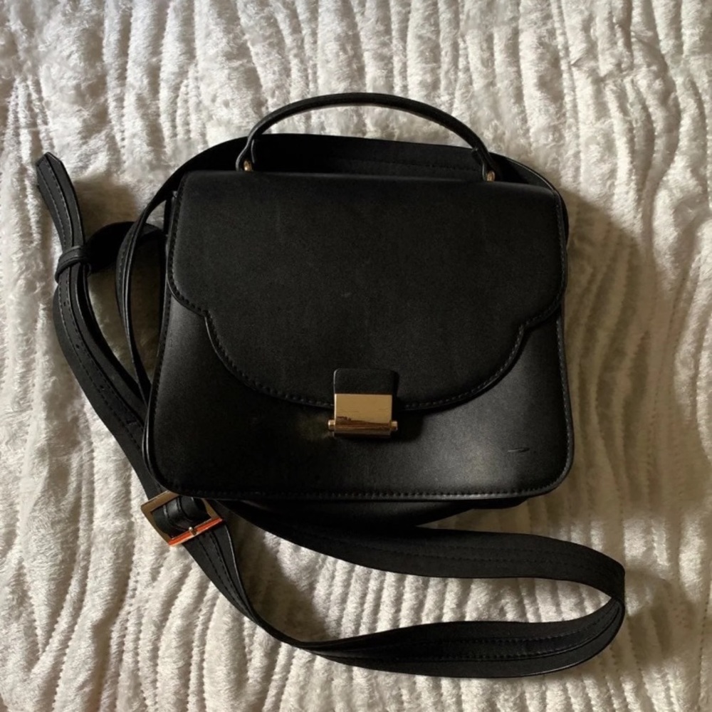 Black messenger bag with gold detailing